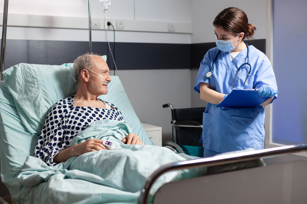 Nurse treating an early-stage bed sore with wound care supplies