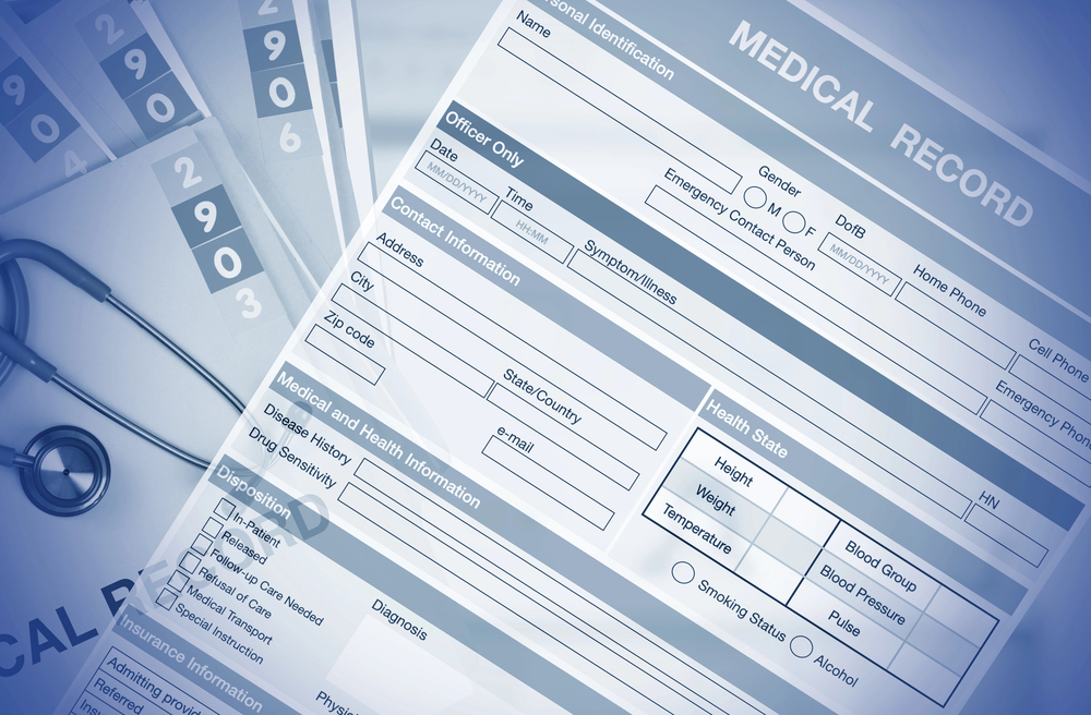 Nursing home abuse attorney in Bloomington, IL reviewing medical records with a client