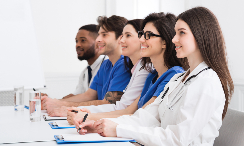 Nursing home staff meeting discussing resident care and responsibilities
